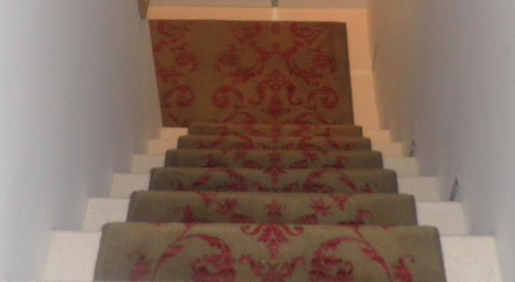 Brintons stair runner fitted to travertine staircase.